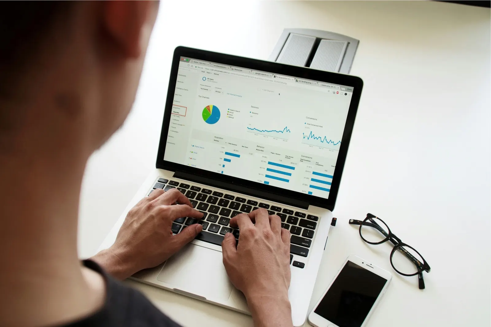 A person reviewing website analytics charts on a laptop