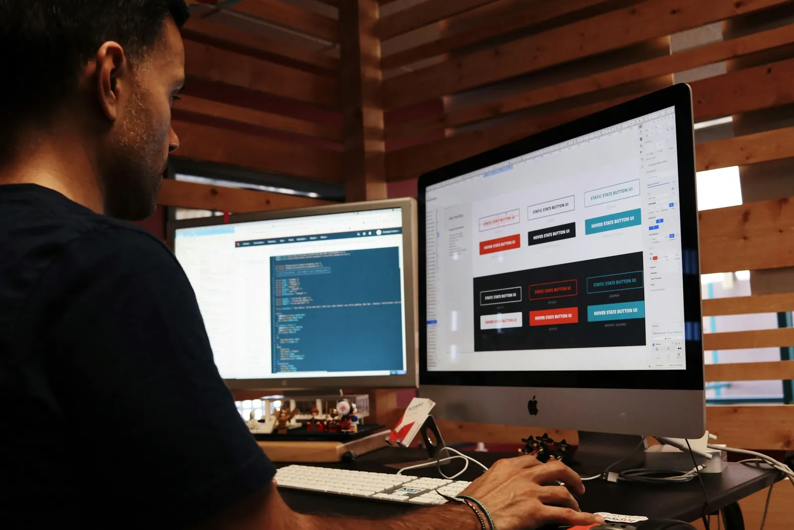 A developer designing web page buttons and layouts on a desktop screen