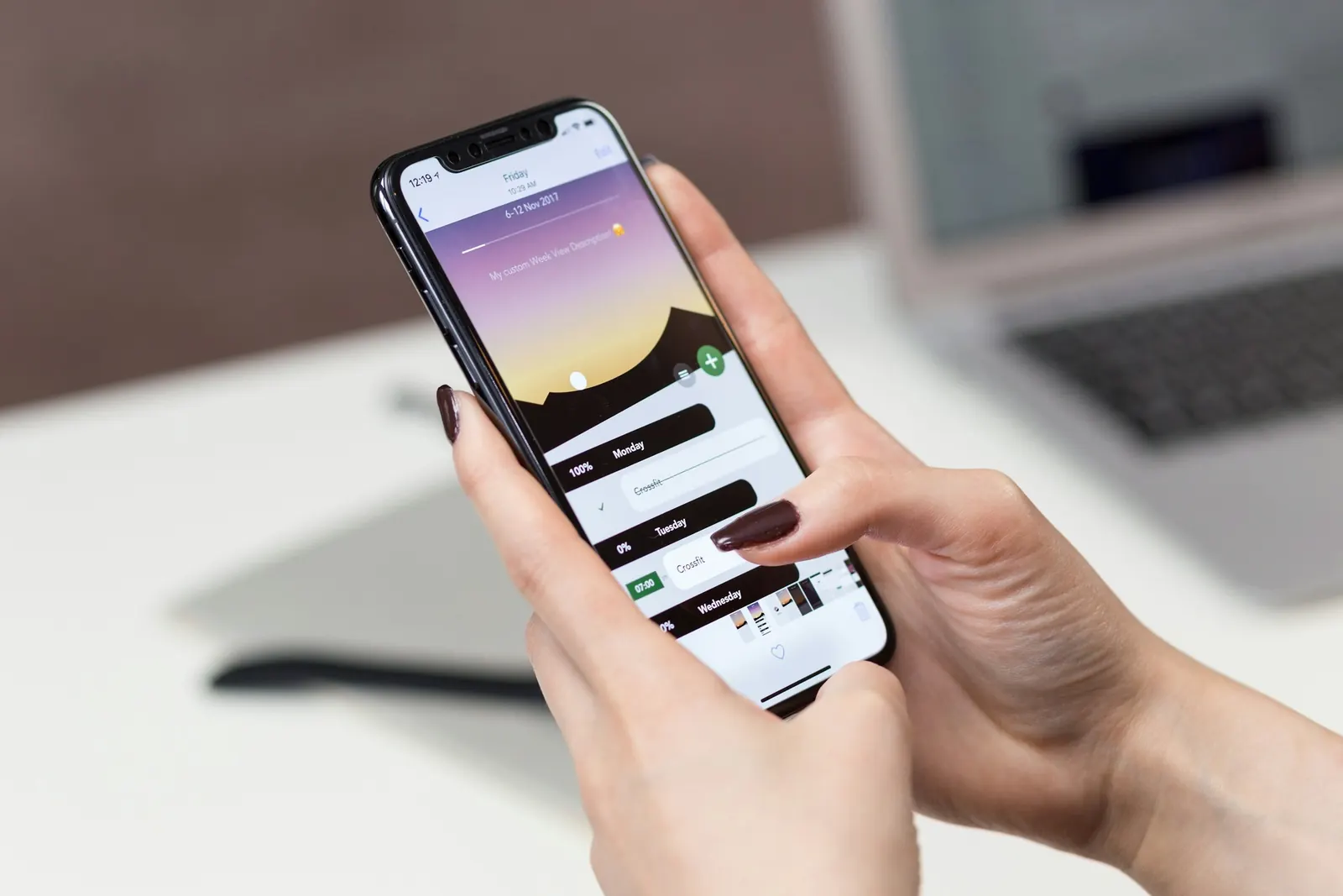 Hands holding a smartphone with a calendar app open