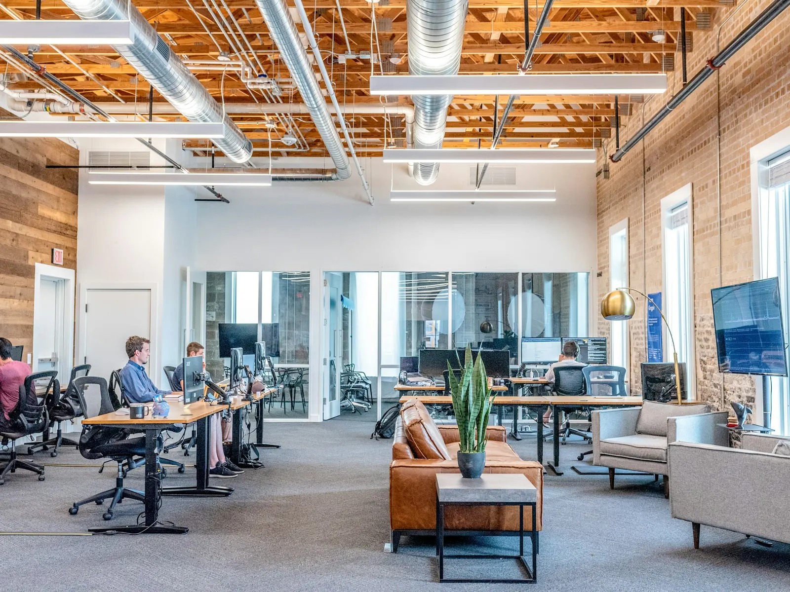 Open-plan office with people working at standing desks